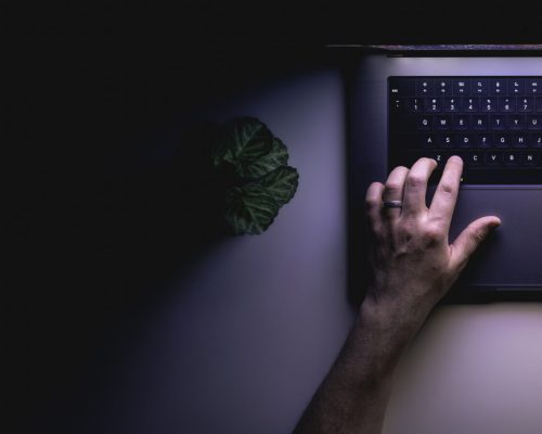 man-using-laptop-night-top-view-web-banner-with-copy-space.jpg